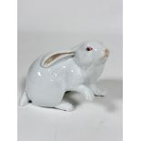 A Herend porcelain model of a white Rabbit, with raised paw, decorated with polychrome enamels (10cm