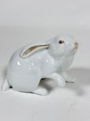 A Herend porcelain model of a white Rabbit, with raised paw, decorated with polychrome enamels (10cm