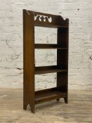 A 1930s oak open bookcase with pierced decoration, three tiers and beaded moulding H92cm, W46cm,