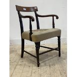 A George III mahogany elbow chair, the scrolled arms over needlework upholstered seat, raised on