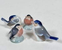 A group of four Danish Royal Copenhagen porcelain miniature bird figures including two Robins on