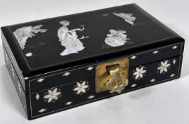 A Japanese black lacquered jewellery box, the top with inlaid mother of pearl carved panels