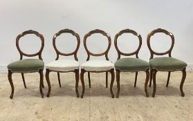 A set of six Victorian mahogany dining chairs, with floral carved crest rail over upholstered seat
