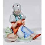 A Herend porcelain figure of a Girl with Goose, decorated with polychrome enamels (17cm x 16cm x