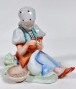 A Herend porcelain figure of a Girl with Goose, decorated with polychrome enamels (17cm x 16cm x