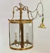 A lacquered brass and glass hall lantern of cylindrical outline, late 20th century, with four