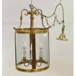 A lacquered brass and glass hall lantern of cylindrical outline, late 20th century, with four