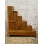 A contemporary cherry wood cabinet of stepped square form, fitted with a combination of drawers