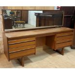 Lawrence of Nottingham, a mid century teak dressing table, the swing mirror over four drawers,