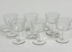 A set of six Edwardian slice cut champagne bowls, on tapered columns and circular bases, (11cm x