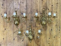 A set of three lacquered brass wall sconces, each with three scrolling branches, H34cm