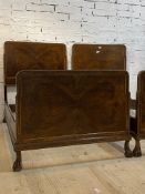 A pair of early 20th century figured walnut 3'6" single beds, with parcel gilt gadrooned moulded