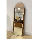 An Art Deco period walnut framed wall hanging mirror, the bevelled plate with serpentine edge