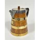 An Edwardian oak brass coopered cylinder ice jug with Epns mounts with masks, spout and shield to
