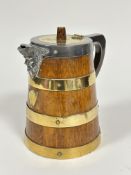 An Edwardian oak brass coopered cylinder ice jug with Epns mounts with masks, spout and shield to