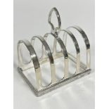 An Epns four division toast rack with Celtic style chased border, with heart shaped handle to