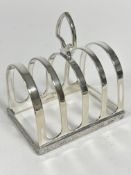 An Epns four division toast rack with Celtic style chased border, with heart shaped handle to