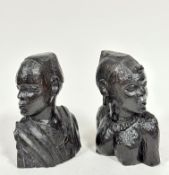 A pair of carved African Nigerian ebony busts of a male and female, (h 23cm)