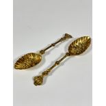 A pair of 19thc gilt metal leaf shaped chased berry spoons, (L 21cm)