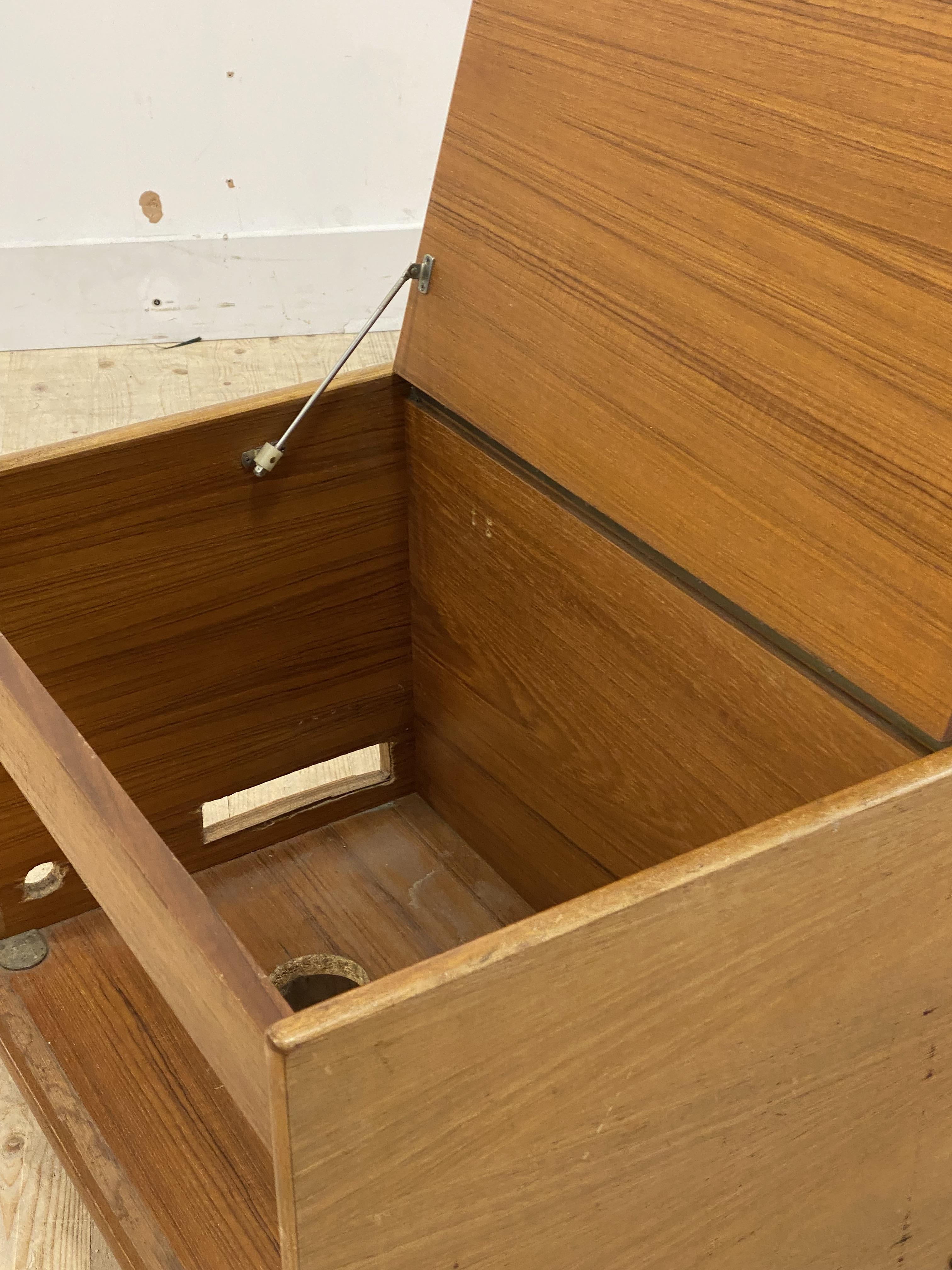 A mid century teak record cabinet, with hinged top, moving on castors, (a/f) H45cm, W82cm, D61cm - Image 2 of 2