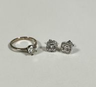 A silver paste set solitaire ring (N), a pair of silver earrings, the central diamond in illusion