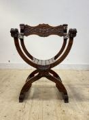 An Italian Dagobert style 'X' frame chair, the arms with stylised mask terminals, raised on sledge