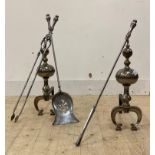 A pair of steel andirons, on scrolling front supports (H51cm) together with a matching fire guard,