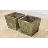 A pair of reconstituted stone planters of square tapered form with Prince of Wales feather motif