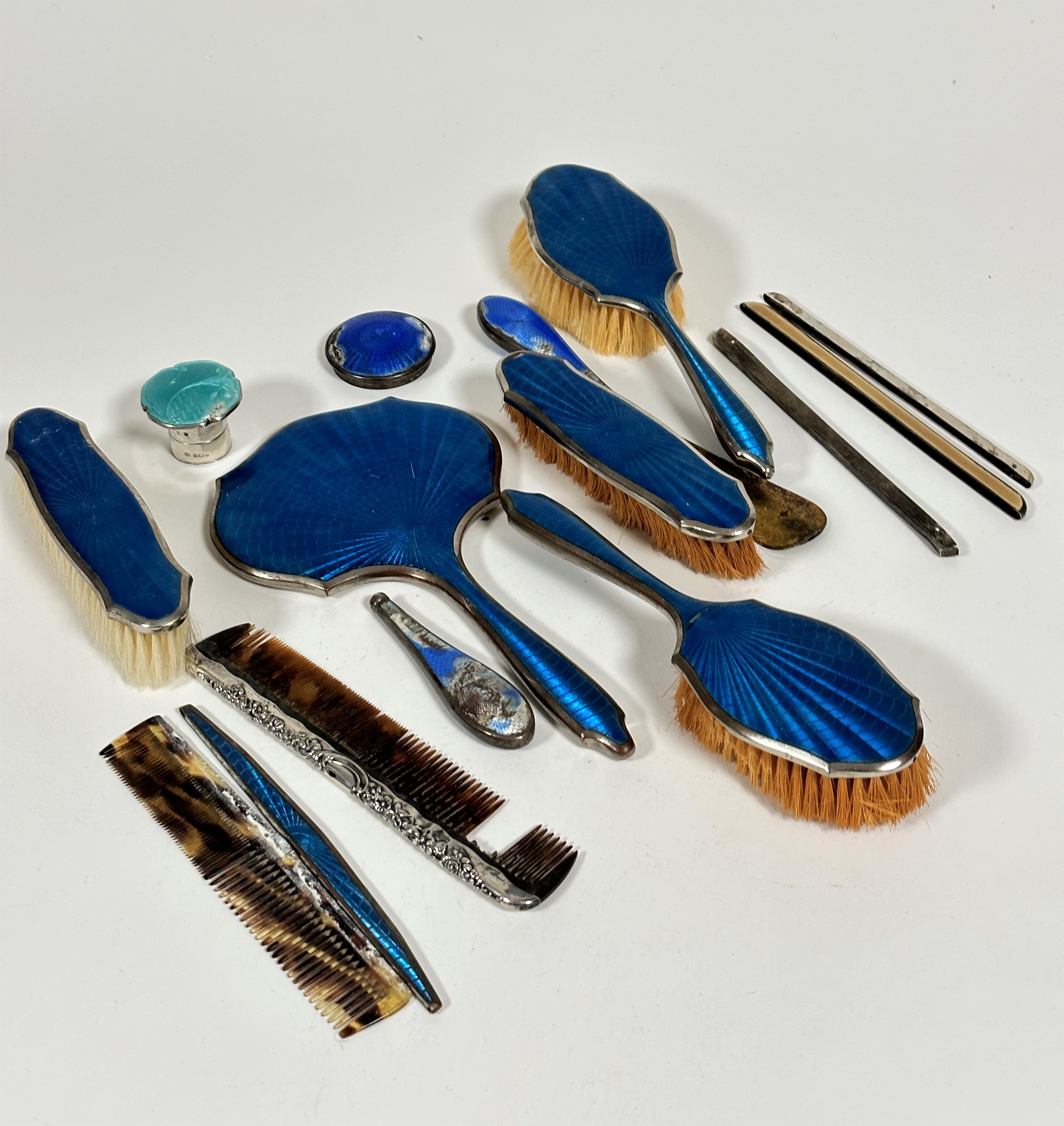 A six piece blue guilloche style enamelled silvered dressing table brush set, an Edwardian silver