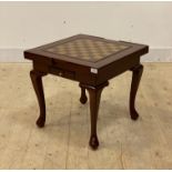 A brass inlaid hardwood games table, with backgammon and chess board, over two drawers raised on