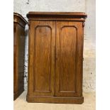 A Victorian mahogany wardrobe, the caddy top over scroll carved frieze and twin panelled doors