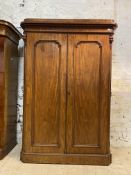 A Victorian mahogany wardrobe, the caddy top over scroll carved frieze and twin panelled doors