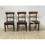 A set of three Victorian mahogany dining chairs with shaped rail backs, rexine upholstered seats,