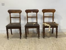 A set of three Victorian mahogany dining chairs with shaped rail backs, rexine upholstered seats,
