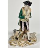 A Continental porcelain figure of a Shepherd playing a flute with seated sheep and standing