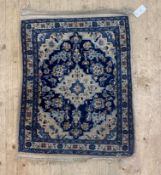 A Persian style rug, the blue field with ivory medallion and spandrels and bordered 56cm x 80cm