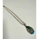 A sterling silver curb link necklace mounted with dragonfly, turquoise and labradorite pear shaped