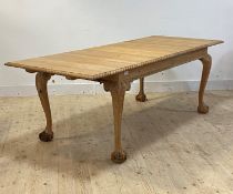A bleached walnut duo drawer leaf extending dining table of Georgian design, the top with