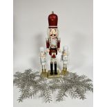 A selection of Christmas decorations including nutcracker style treen drummer figure on gilt