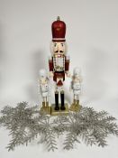 A selection of Christmas decorations including nutcracker style treen drummer figure on gilt