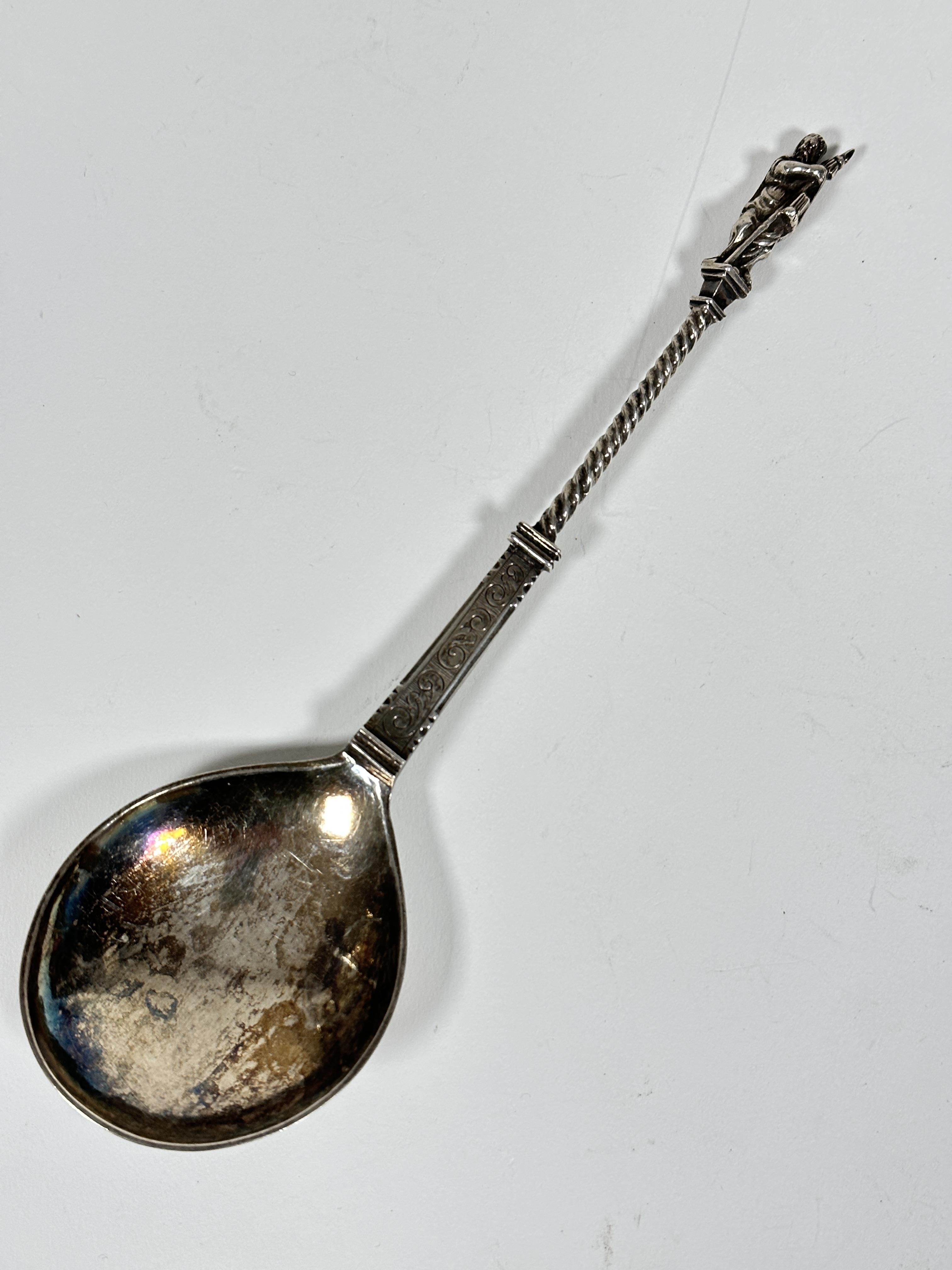 A 19thc Continental apostle spoon with spiral twist handle and figure holding a spear with scrolling