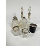 Three various silver and white metal mounted perfume bottles, a white metal mounted scent bottle, an