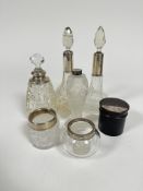 Three various silver and white metal mounted perfume bottles, a white metal mounted scent bottle, an