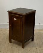 A stained walnut bedside table, the panelled door opening to a shelf H70cm W42cm, D40cm