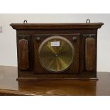 An oak cased aneroid barometer, the frame with two clothes brushes W54cm