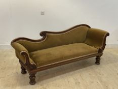 A William IV mahogany scroll arm sofa, upholstered in green velvet, raised on scroll carved turned