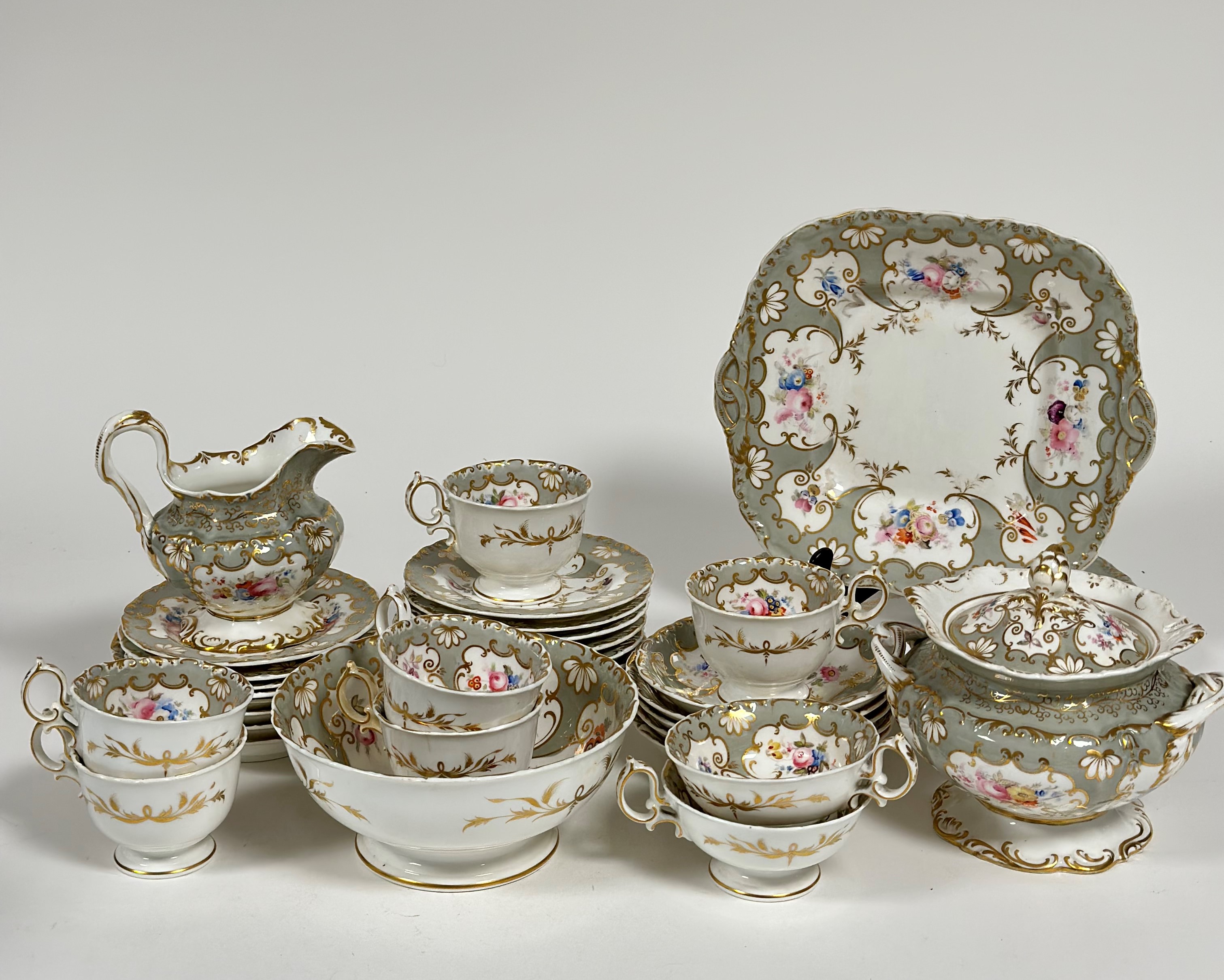 A 19th century Derby part tea service decorated with gold gilding and silver and floral enameling,