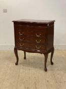 A brass inlaid mahogany canteen chest, the hinged top over three drawers, raised on cabriole