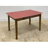 A mid century kitchen dining table, the red formica top over frieze drawer, raised on square tapered