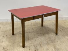 A mid century kitchen dining table, the red formica top over frieze drawer, raised on square tapered